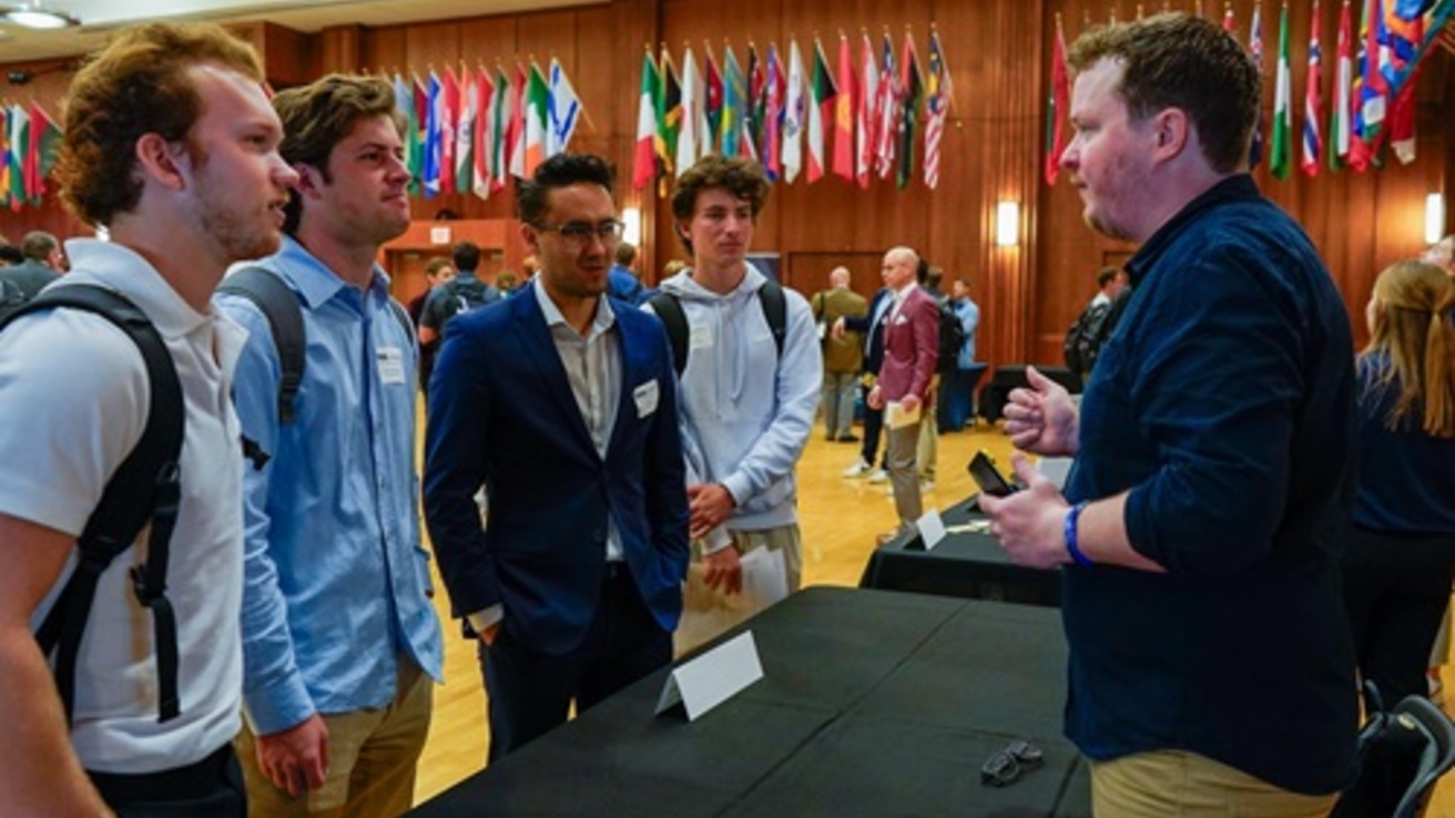 Students talking to employer